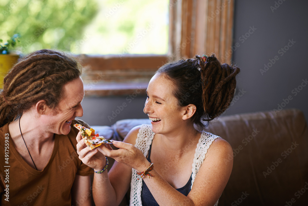 Theres nothing as tasty as pizza. Shot of a Rastafarian couple eating pizza. Theres nothing as tasty as pizza. Shot of a Rastafarian couple eating pizza.