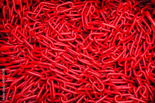 A bunch of red chains close-up. Texture and background of chains.
