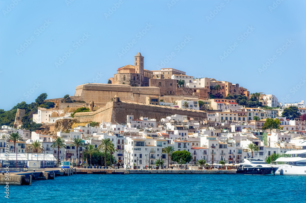 A sea side view to the Ibiza Old Town with Cathedral of Santa Maria d`Eivissa at the top of the hill in Ibiza, Spain.