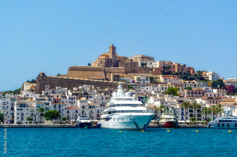Luxurious yachts docket at port of Ibiza during summer day.