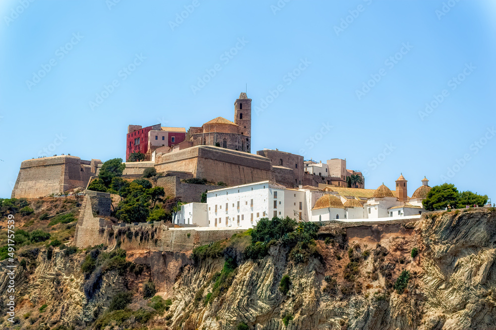 A view from the sea side to the Ibiza Old Town with Cathedral of Santa Maria d`Eivissa at the top of the hill in Ibiza, Spain.