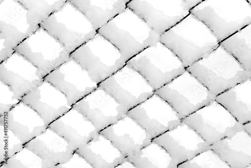 Background texture made of rabitz grid covered with snow.