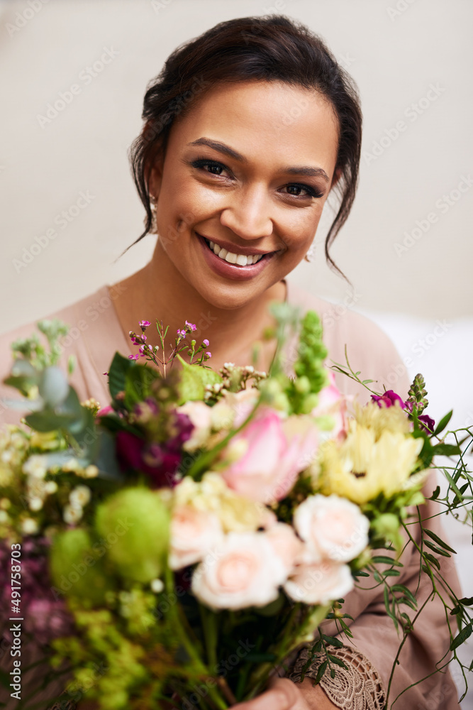 Im the happiest woman on earth today. Cropped portrait of a beautiful young bride holding a bouquet of flowers while sitting in her dressing room on the morning of her wedding. Im the happiest woman on earth today. Cropped portrait of a beautiful young bride holding a bouquet of flowers while sitting in her dressing room on the morning of her wedding.
