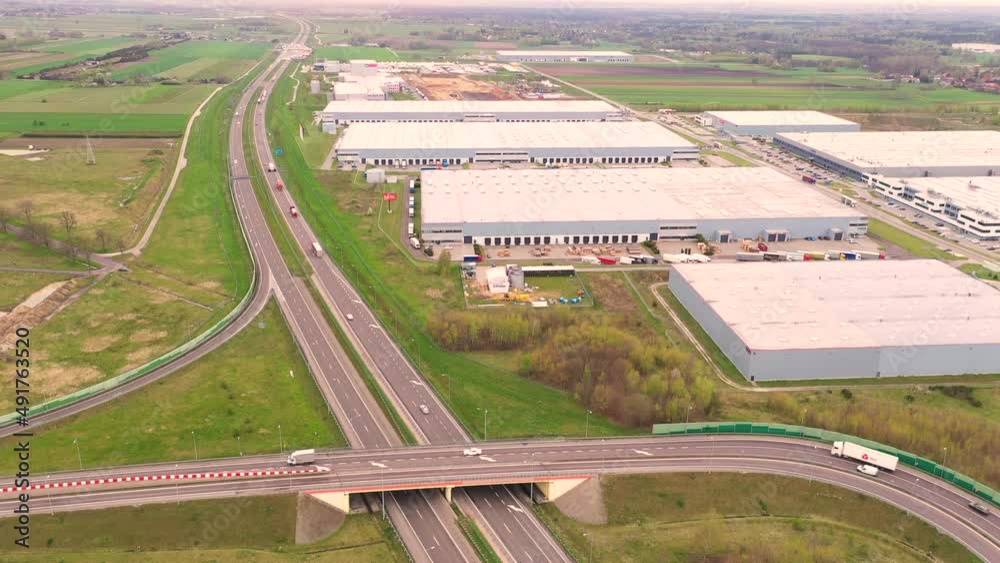 Aerial Shot of Industrial Warehouse Storage Building Loading Area where Many Trucks Are Loading Unloading Merchandise. Shot on Phantom 4K UHD Camera. Aerial Shot of Industrial Warehouse Storage Building Loading Area where Many Trucks Are Loading Unloading Merchandise. Shot on Phantom 4K UHD Camera.