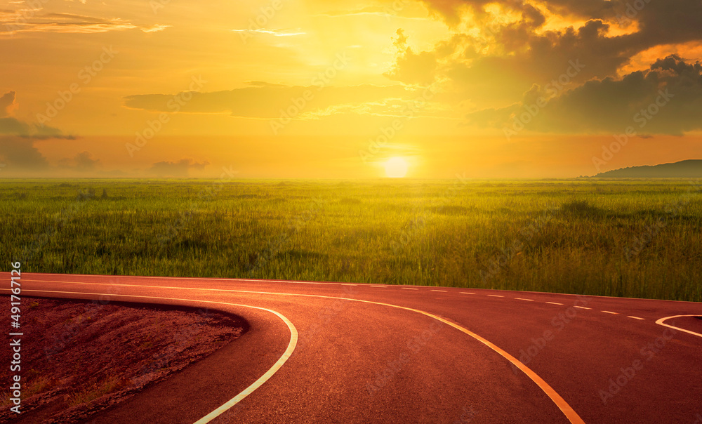 Asphalt curve road, sunset and beautiful roadside views in the countryside.