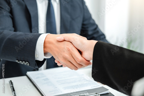 Business Shaking hands greeting new colleagues after during job interview