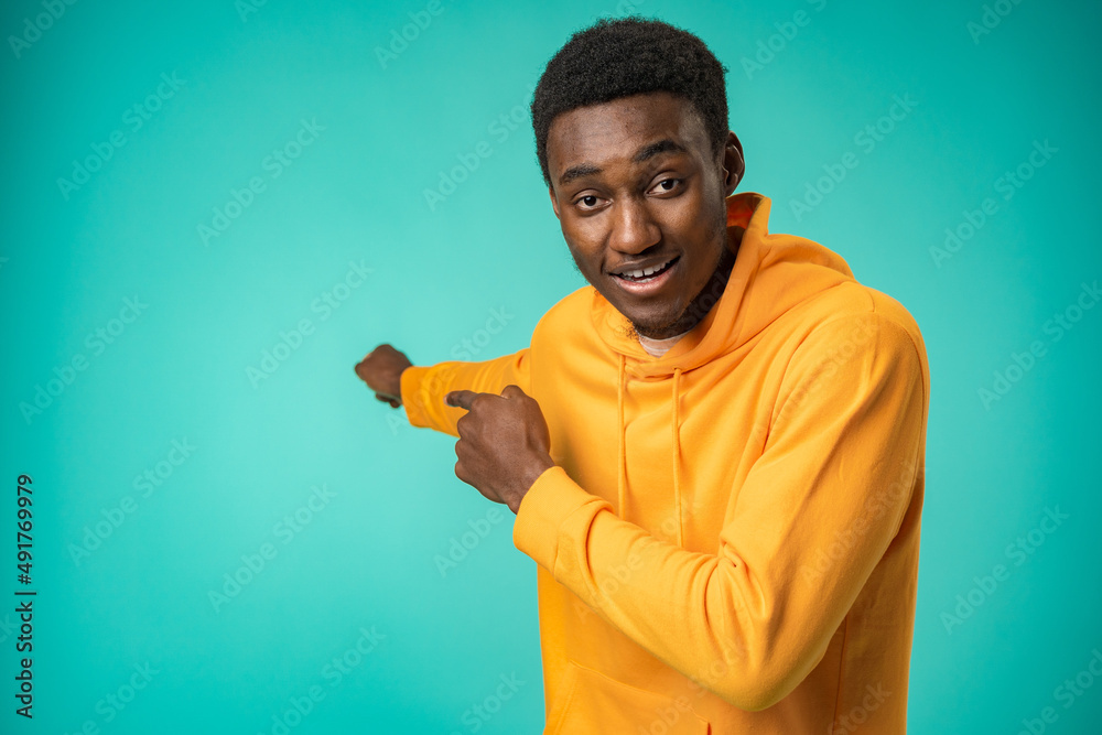 Happy African American man pointing finger at copy space Happy African American man pointing finger at copy space