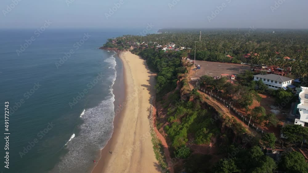 Beautiful Aerial Drone Shot Of Varkala Beach Coastal Area Filled With Hotels, And Trees Beautiful Aerial Drone Shot Of Varkala Beach Coastal Area Filled With Hotels, And Trees