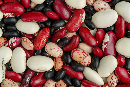 Fotografie Mixed legumes beans background. Top view