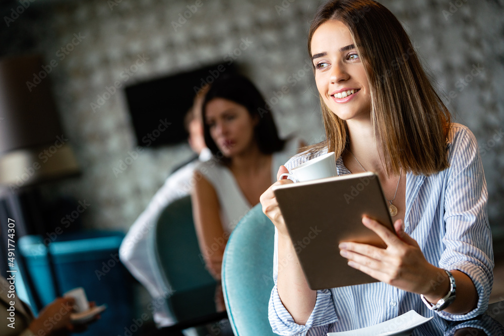 Happy woman manager holding tablet and sitting in cafe Happy woman manager holding tablet and sitting in cafe
