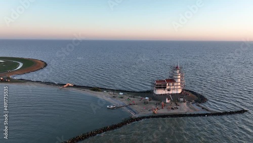 Aerial view of the Paard van Marken at sunrise traditional historic monument lighthouse on the island of Marken in The Netherlands. Small fishing village in Europe. photo