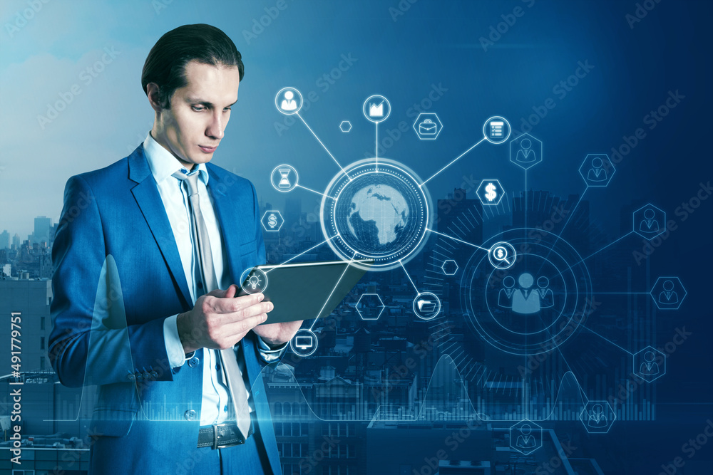 Portrait of attractive businessman hand pointing at tablet with abstract glowing business data and earth hologram on blurry blue city background. Communication and media concept. Double exposure. Portrait of attractive businessman hand pointing at tablet with abstract glowing business data and earth hologram on blurry blue city background. Communication and media concept. Double exposure.