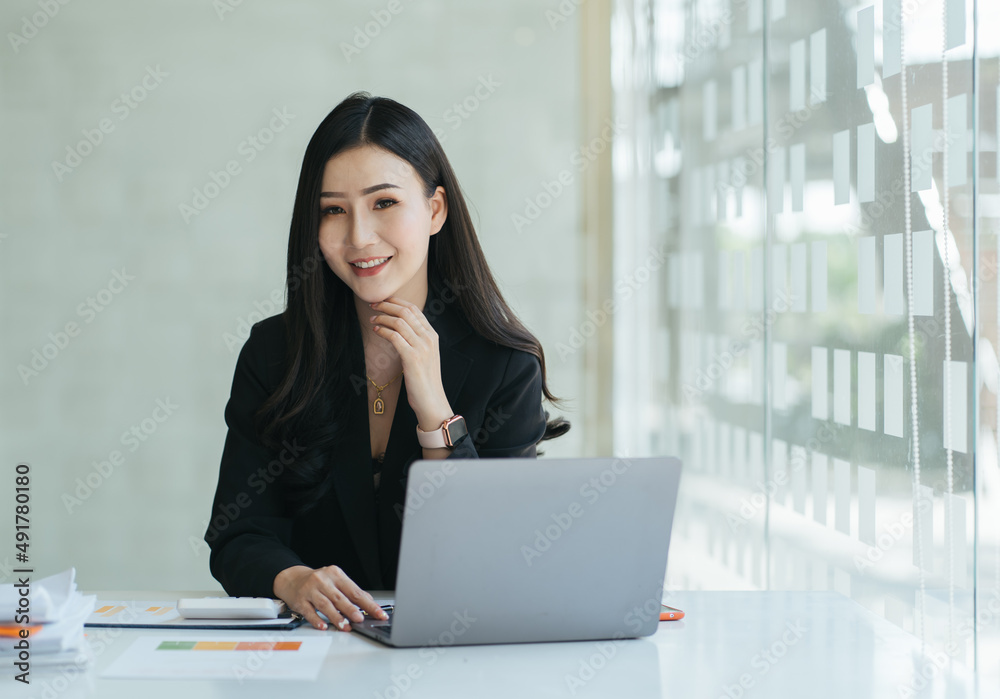 Beauitul young woman working using computer laptop concentrated and smiling Beauitul young woman working using computer laptop concentrated and smiling
