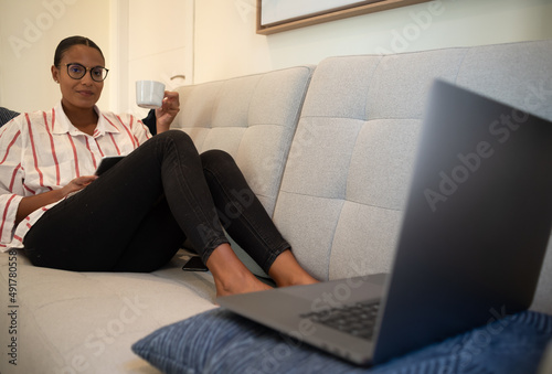 Woman working on the sofa with the laptop photo