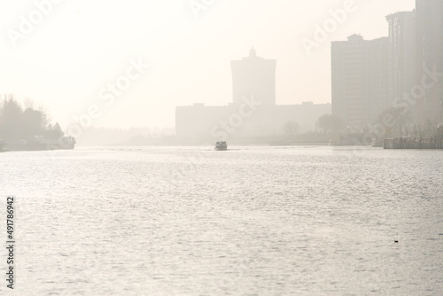 heavy fog. the boat floats on the river