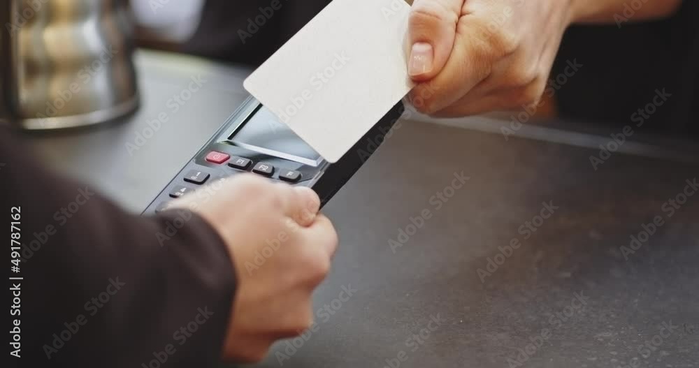 Close-up of Woman paying credit card via the terminal without entering the PIN code,smart payment,contactless payment,e-money,digital money.Barman woman in medical mask, business reopen after covid