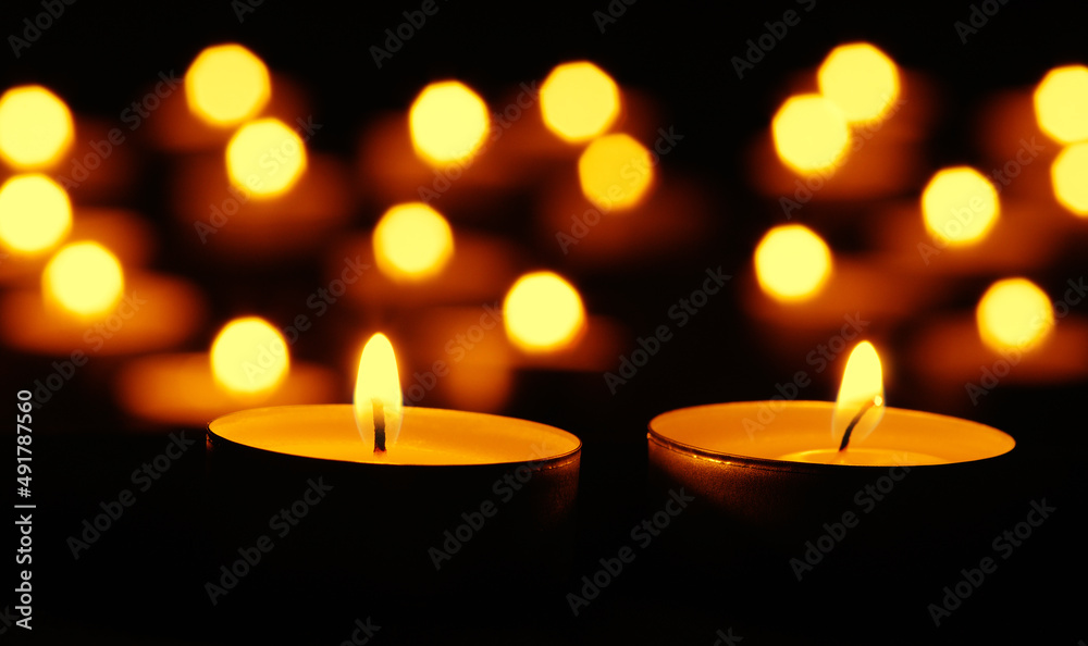 Many burning candles with bokeh light background Many burning candles with bokeh light background