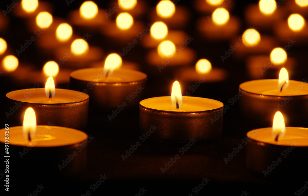 Many burning candles with bokeh light background