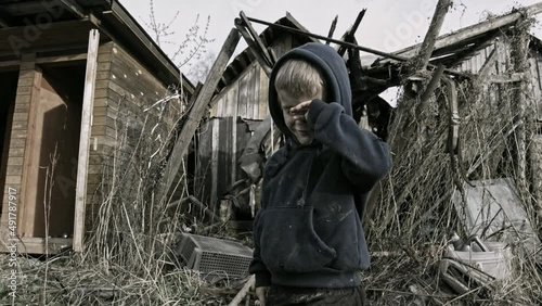 Child playing war in ruins photo