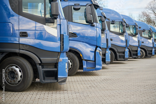 Fotografie, Obraz Fleet of commercial lorry trucks in row