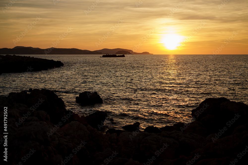 Cala Viola de Ponent, Menorca. September 2021. Magnificent sunset in the Mediterranean Sea. On one of the paradisaical beaches of the island of Menorca.