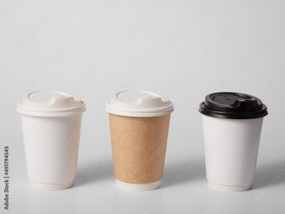 Three takeaway paper cups on white background. Three takeaway paper cups on white background.