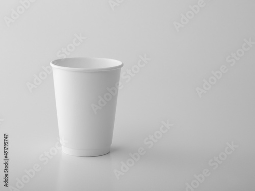 White takeaway paper cup on white background.