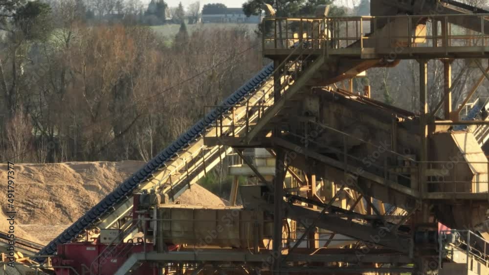 Aerial shot of machines and trucks working in a sand quarry, in France. Those are extracting and filtering the sand. Aerial shot of machines and trucks working in a sand quarry, in France. Those are extracting and filtering the sand.