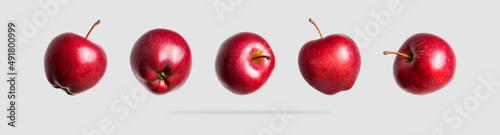 Red fresh apples isolated on light gray background. Whole ripe apples. Sweet summer fruit, organic natural apple. Apple set for design and advertising. Concept of food and harvest