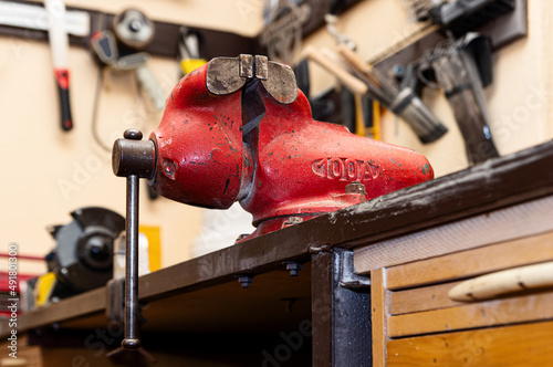 Canvas Print Close up of red vice clamp. Heavy tool concept. Rusty old vise.