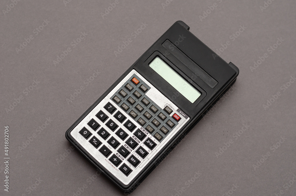 Scientific calculator against gray background. Scientific calculator against gray background.