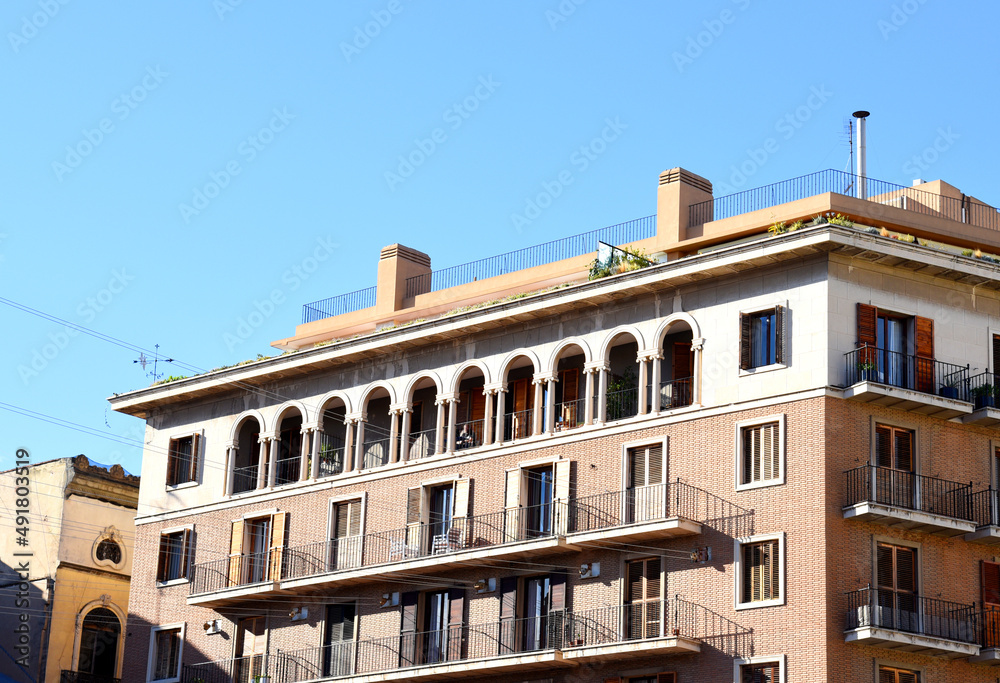 Facade of a building. Residential building with balconies. Colorful buildings and hotel apartments. Facade of residential building in Spain. House with window and balcony. Buildings architecture 