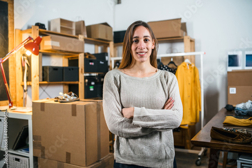 Portrait of a business woman arms folded, self-confident - Young female sells products online - Millennial uses websites to market second hand clothing that does not use - Start up concept