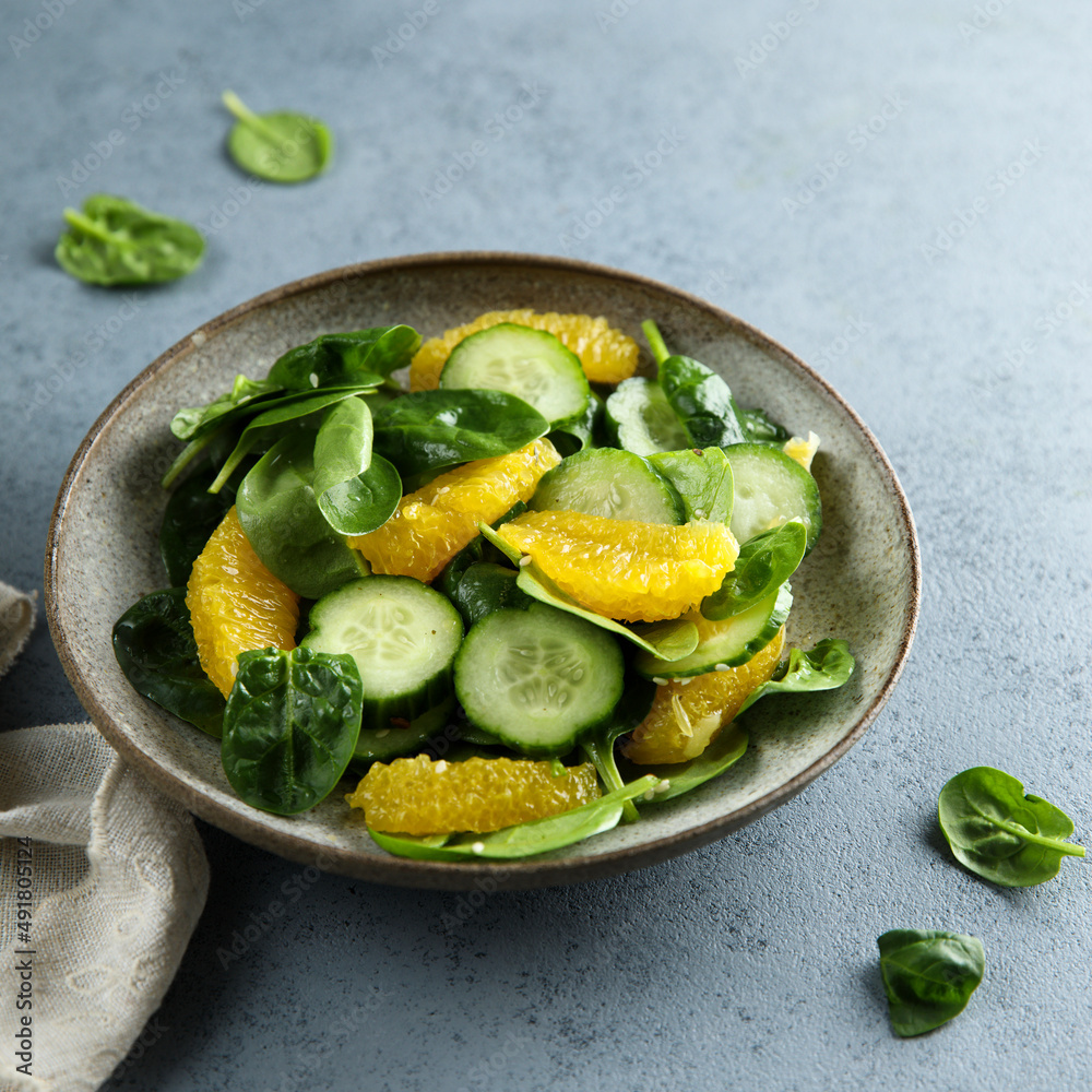 Healthy spinach salad with orange and cucumber Healthy spinach salad with orange and cucumber