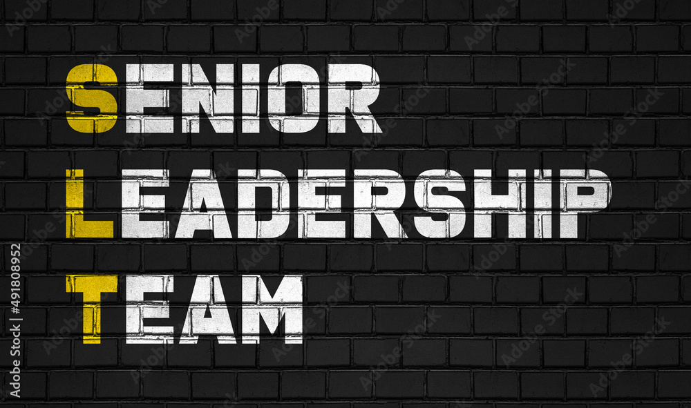 senior leadership team (SLT) concept,business abbreviations on black wall 