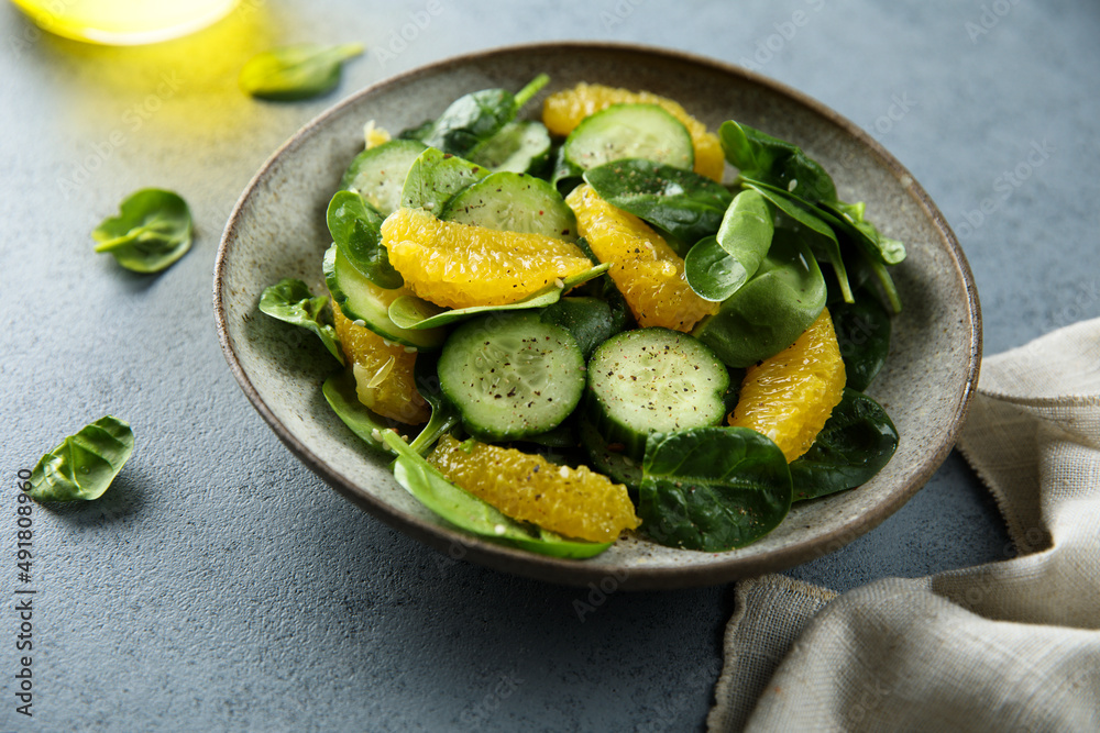 Healthy spinach salad with orange and cucumber Healthy spinach salad with orange and cucumber
