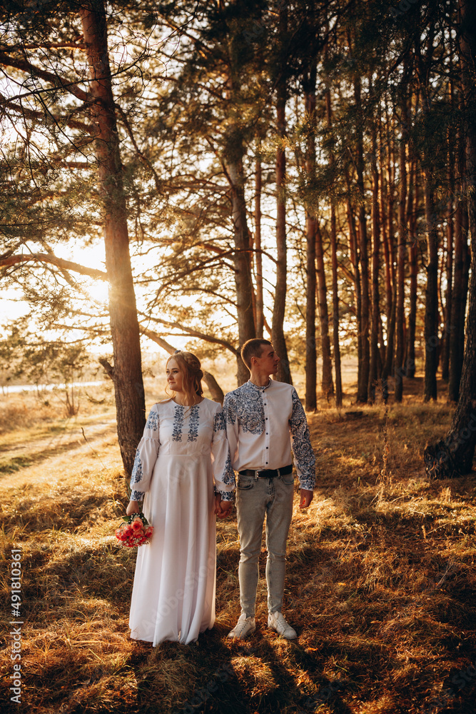Bride and groom in Ukrainian national clothes. Wedding embroidered clothes. Wedding in the Ukrainian style. Happy bride in traditional Ukrainian embroidered dress. Ukrainian patriots Bride and groom in Ukrainian national clothes. Wedding embroidered clothes. Wedding in the Ukrainian style. Happy bride in traditional Ukrainian embroidered dress. Ukrainian patriots