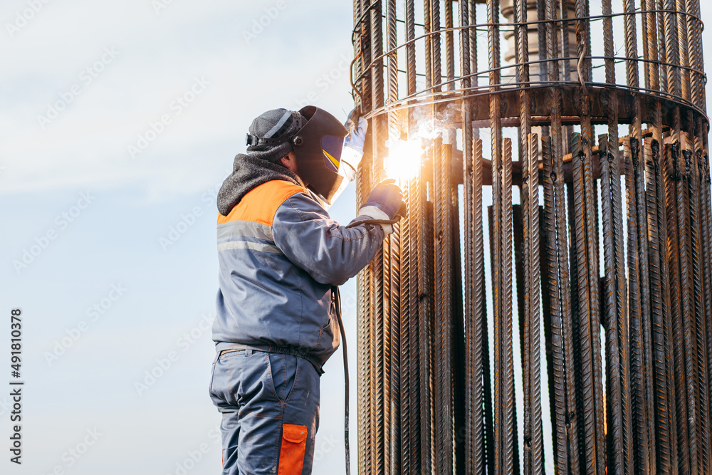 Workers is welding metal parts of concrete bridge Workers is welding metal parts of concrete bridge