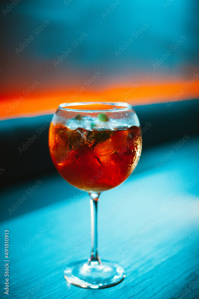glass of red wine on blue background