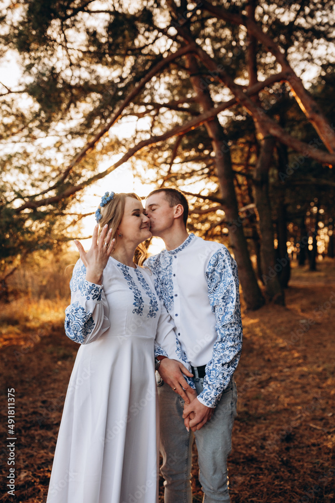 Bride and groom in Ukrainian national clothes. Wedding embroidered clothes. Wedding in the Ukrainian style. Happy bride in traditional Ukrainian embroidered dress. Ukrainian patriots