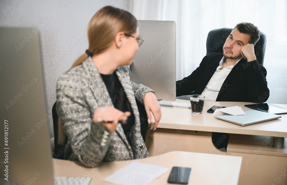 Young attractive woman and adult man are working in the office. Open space concept for teamwork Young attractive woman and adult man are working in the office. Open space concept for teamwork