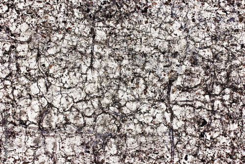 White paint asphalt cracks texture. Scratched lines background. White and black distressed grunge concrete wall pattern for graphic design. Dirty and destroyed surface. War destruction texture.