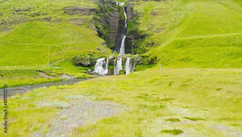 FPV Drone Flying Under Bridge To Reveal Beautiful Cascade Gluggafoss In Iceland. 4K Drone. photo