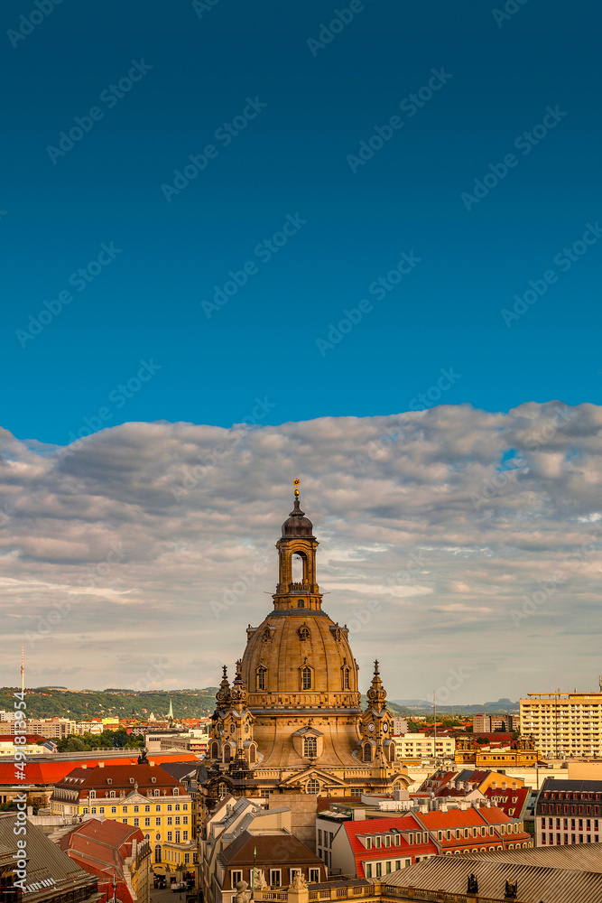 Cover page with bird view of the church of our Lady (Frauenkirche) at Neumarkt square in historical downtown of Dresden in summer with blue sky and sunset, Germany.