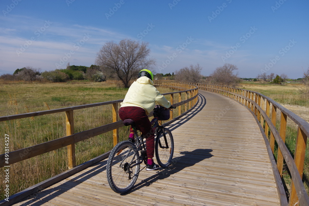 Cycliste sur une piste cyclable voie verte sur un ponton en bois
