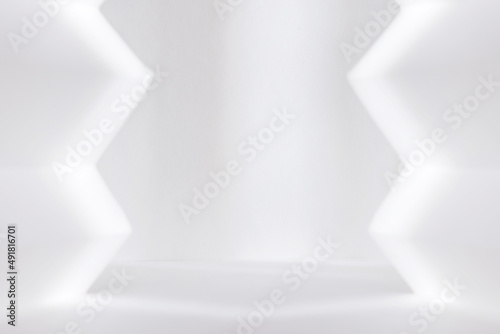 Abstract white studio background for product presentation. Empty room with shadows of window. Display product with blurred backdrop.