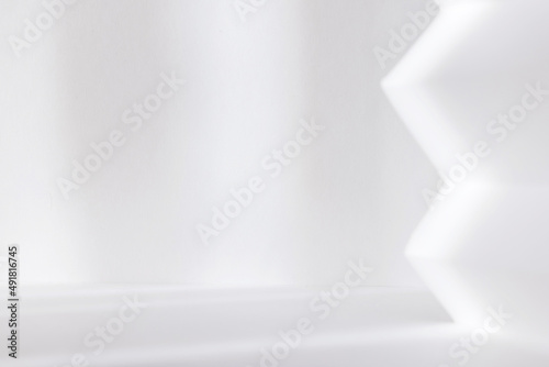 Abstract white studio background for product presentation. Empty room with shadows of window. Display product with blurred backdrop.