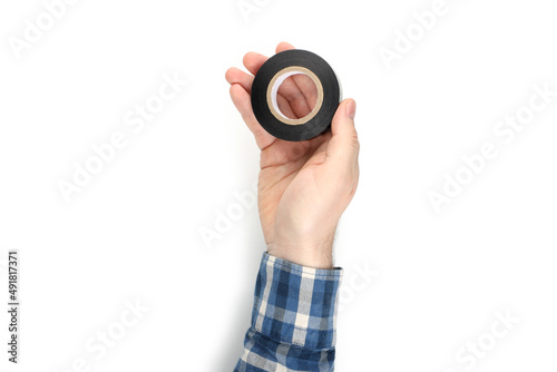 Fotografia Male hand holds insulating tape, isolated on white background