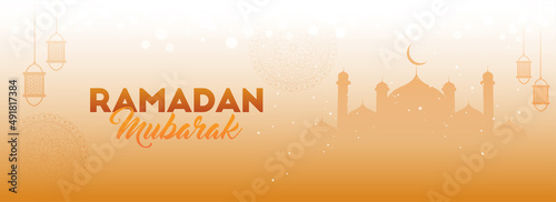 Ramadan Mubarak Concept With Silhouette Mosque And Lanterns Hang On Glossy Orange Bokeh Light Effect Background.