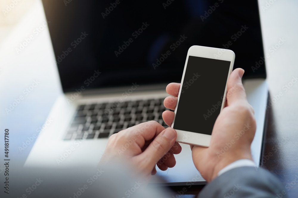 Prepared for productivity. Cropped shot of corporate businessmen texting on a cellphone.